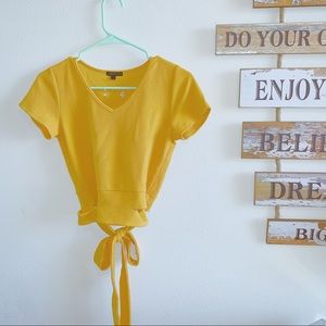 Gold form fit crop top with a cute tie around!